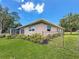 The exterior shows the home's well-manicured lawn and landscaping with a partially fenced yard at 1137 Indian Rocks S Rd, Largo, FL 33770