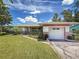 Charming single-story home featuring a well-manicured lawn and a one-car garage at 1137 Indian Rocks S Rd, Largo, FL 33770
