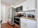 Modern kitchen with stainless steel appliances, including a refrigerator, oven, and microwave at 1137 Indian Rocks S Rd, Largo, FL 33770