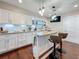 Modern kitchen featuring white cabinets, granite countertops, stainless steel appliances, and a stylish island with bar seating at 1137 Indian Rocks S Rd, Largo, FL 33770