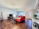 Bright and airy living room with hardwood floors, comfortable red sofas, and ample natural light at 1137 Indian Rocks S Rd, Largo, FL 33770