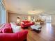 Expansive living room with hardwood floors, comfortable seating, and an open layout connecting to the dining area at 1137 Indian Rocks S Rd, Largo, FL 33770
