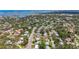 Expansive aerial photograph displays neighborhood near a bay, showcasing mature trees and diverse rooftops at 1137 Indian Rocks S Rd, Largo, FL 33770