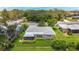 Charming home featuring a cozy screened-in porch and a well-maintained lawn with vibrant landscaping at 1137 Indian Rocks S Rd, Largo, FL 33770