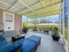 Enclosed patio with furniture for relaxing and beautiful views of the surrounding trees and greenery at 1137 Indian Rocks S Rd, Largo, FL 33770
