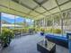 Enclosed patio with furniture for relaxing and beautiful views of the surrounding trees and greenery at 1137 Indian Rocks S Rd, Largo, FL 33770