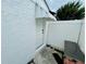 Side door of home features awning, concrete pad and fenced walkway at 6806 Monique Ave, Tampa, FL 33625