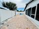Fenced backyard with paved area, in-ground pool and screened lanai at 6806 Monique Ave, Tampa, FL 33625