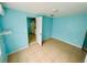 Bright bedroom with tiled floor showing doorway view to kitchenette at 6806 Monique Ave, Tampa, FL 33625