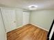 Bedroom features wood-look flooring, double closets, and a modern ceiling fan/light fixture at 6806 Monique Ave, Tampa, FL 33625