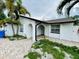 Close-up of the arched entryway with brick flooring and a white stucco exterior at 6806 Monique Ave, Tampa, FL 33625