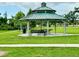 Picturesque park gazebo surrounded by lush green lawns and trees, ideal for outdoor gatherings at 6806 Monique Ave, Tampa, FL 33625