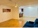 Open-concept living room with modern lighting and tile flooring with access to the kitchen at 6806 Monique Ave, Tampa, FL 33625