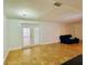 Bright living room with tile floors, glass patio doors, contemporary lighting, and a blue sofa at 6806 Monique Ave, Tampa, FL 33625