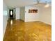 Spacious living room with glossy tile floors, neutral walls, ceiling fan and a view of the front entry door at 6806 Monique Ave, Tampa, FL 33625