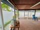 View of the covered, screened patio, featuring brick flooring and view of the pool at 6806 Monique Ave, Tampa, FL 33625