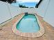 Private pool surrounded by brick paving and a white fence at 6806 Monique Ave, Tampa, FL 33625