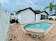 Backyard pool area featuring a pool, pool-side seating, brick pavers, and house exterior at 6806 Monique Ave, Tampa, FL 33625
