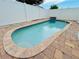 Private kidney bean shaped pool with brick pavers and privacy fence at 6806 Monique Ave, Tampa, FL 33625