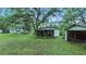 Expansive backyard with a screened porch and mature trees at 242 Zoller St, Brooksville, FL 34601