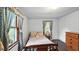 Cozy bedroom with natural light, featuring a bed and a wooden dresser, creating a calm atmosphere at 242 Zoller St, Brooksville, FL 34601