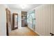 Small bedroom with a closet space and patterned wallpaper, bathed in natural light from a window at 242 Zoller St, Brooksville, FL 34601