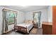 Comfortable bedroom with natural light, featuring a bed and a wooden dresser, creating a calm atmosphere at 242 Zoller St, Brooksville, FL 34601