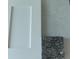 Close-up showcases a clean white cabinet door paired with a sample of speckled black granite for a stylish interior at 5461 Ocean Breeze Dr, Spring Hill, FL 34609