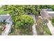 Aerial view of the home surrounded by mature trees, showing the driveway at 7318 Tranquil Dr, Spring Hill, FL 34606