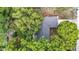 Aerial view of the home showcasing the roof and mature trees on the property at 7318 Tranquil Dr, Spring Hill, FL 34606