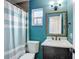 Bright bathroom with colorful walls, a tub-shower combo, and vanity sink at 7318 Tranquil Dr, Spring Hill, FL 34606