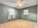This is a bedroom with carpet floors, ceiling fan, and natural light from two windows at 7318 Tranquil Dr, Spring Hill, FL 34606