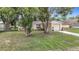 Cozy one-story home surrounded by mature trees and lush landscaping at 7318 Tranquil Dr, Spring Hill, FL 34606