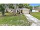 Charming single-story home featuring a well-manicured lawn and a one-car garage at 7318 Tranquil Dr, Spring Hill, FL 34606