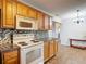 A kitchen featuring white appliances, granite countertops, and mosaic backsplash at 7318 Tranquil Dr, Spring Hill, FL 34606