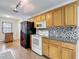 A well-equipped kitchen featuring wood cabinets, tile backsplash, and modern appliances at 7318 Tranquil Dr, Spring Hill, FL 34606