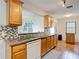 Traditional kitchen featuring stainless sink, mosaic backsplash, granite countertops, and wood cabinets at 7318 Tranquil Dr, Spring Hill, FL 34606