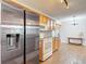 View of kitchen and dining area with stainless refrigerator and tile flooring at 7318 Tranquil Dr, Spring Hill, FL 34606