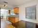 Traditional kitchen featuring stainless sink, mosaic backsplash, granite countertops, and wood cabinets at 7318 Tranquil Dr, Spring Hill, FL 34606