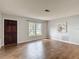 Inviting living room featuring a front door, large window, and beautiful wood-look tile flooring at 7318 Tranquil Dr, Spring Hill, FL 34606