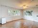 Living room featuring hard floors, multiple windows, and ceiling fan at 7318 Tranquil Dr, Spring Hill, FL 34606