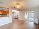 Living room featuring tile flooring, ceiling fan, and access to outdoor screened-in patio at 7318 Tranquil Dr, Spring Hill, FL 34606