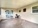 The covered patio has direct access to the house through sliding glass doors at 7318 Tranquil Dr, Spring Hill, FL 34606