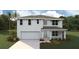 Inviting two-story home with a two-car garage, neutral paint, and lush landscaping at 7715 Rome Ln, Brooksville, FL 34613