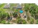 Aerial view of fenced yard with above ground pool, shed, trampoline, and view of house at 14025 Canyon Swallow Rd, Weeki Wachee, FL 34614
