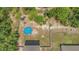 Aerial view of the property featuring an above-ground pool, and a large backyard surrounded by lush trees at 14025 Canyon Swallow Rd, Weeki Wachee, FL 34614