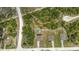 Aerial view showcasing a neighborhood with homes featuring spacious yards, above-ground pools, and wooded surroundings at 14025 Canyon Swallow Rd, Weeki Wachee, FL 34614