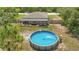 Home with a large yard, fenced backyard with an above-ground pool, and a covered patio for relaxing at 14025 Canyon Swallow Rd, Weeki Wachee, FL 34614