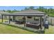 Spacious covered patio with outdoor dining and seating, perfect for entertaining or relaxing outdoors at 14025 Canyon Swallow Rd, Weeki Wachee, FL 34614