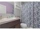 Bathroom featuring dark wood vanity, patterned shower curtain, and updated fixtures at 14025 Canyon Swallow Rd, Weeki Wachee, FL 34614
